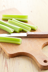 Image showing green celery sticks on kitchen table