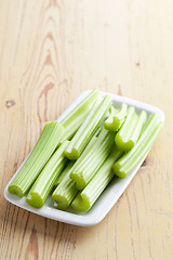 Image showing green celery sticks on kitchen table