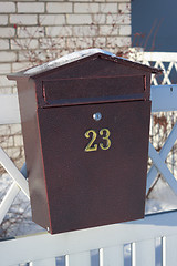 Image showing Mailbox hanging on a white fence