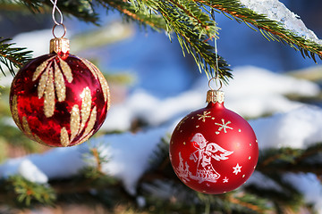 Image showing christmas balls on outdoor snowy tree