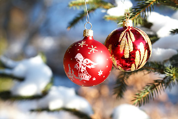 Image showing christmas balls on outdoor snowy tree