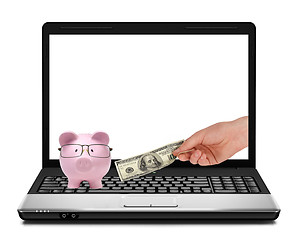 Image showing Conceptual image of piggy bank, dollars and laptop