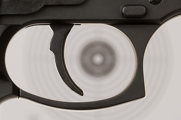 Image showing The trigger of a handgun with a shooting target 