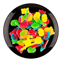 Image showing Colorful candies in many different shapes isolated on a black pl