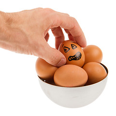 Image showing Scared egg, waiting to be grabbed by a hand