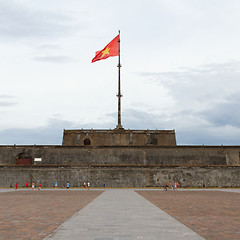 Image showing HUE, VIETNAM - AUG 4: Boys playing football in front of the Flag