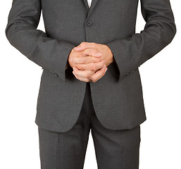 Image showing Business man in grey suit praying