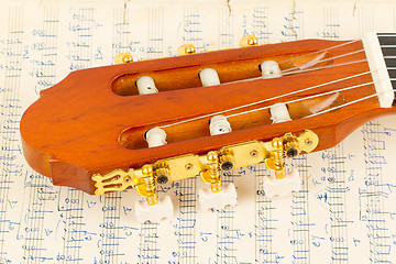 Image showing Old music sheet and a guitar