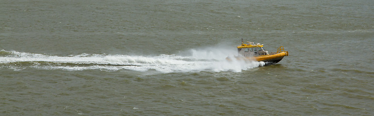 Image showing Yellow Crewtender at high speed