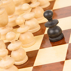 Image showing Black pawn on a wooden chessboard