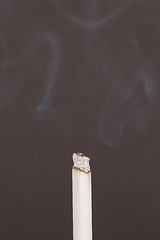 Image showing Burning cigarette with smoke