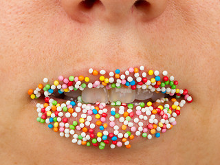 Image showing Woman lips with multicolored pearls 