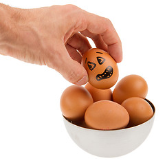 Image showing Scared egg, waiting to be grabbed by a hand