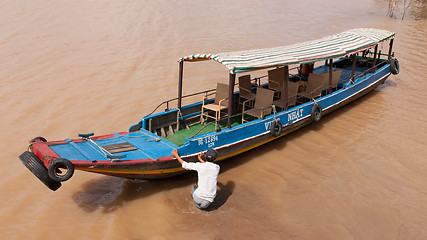 Image showing MEKONG DELTA, VIETNAM, 12 AUGUST 2012 - Tourist guide pushes a b