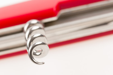 Image showing Red swiss army knife isolated, focus on corkscrew