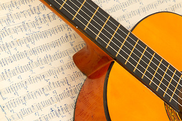 Image showing Old music sheet and a guitar