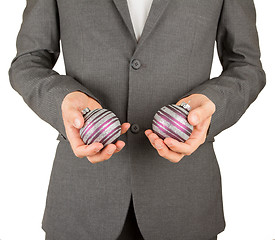 Image showing Man in grey suit is holding Christmass balls