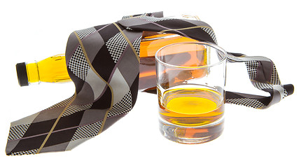 Image showing Glass of whisky, a bottle and a tie