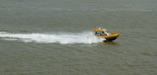 Image showing Yellow Crewtender at high speed