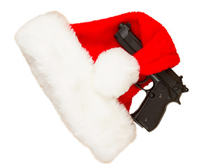 Image showing Weapon (firearm) concealed in santas hat