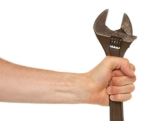 Image showing Old rusted adjustable vector wrench in a hand