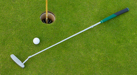 Image showing Golf hole with ball and putt