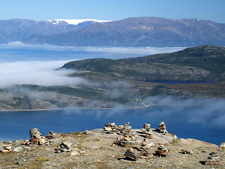 Image showing Sea of clouds above an island