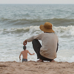Image showing Man sitting on the beach at the south chinese sea 
