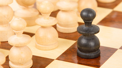 Image showing Black pawn on a wooden chessboard