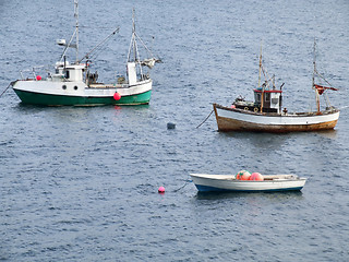 Image showing Two fishing ships and a boat on anchor