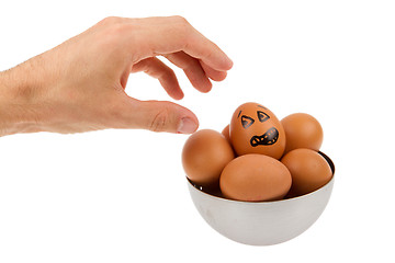 Image showing Scared egg, waiting to be grabbed by a hand