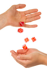Image showing Five red dice being thrown from a hand