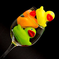 Image showing Yellow, orange and green rubber duck in a wineglass