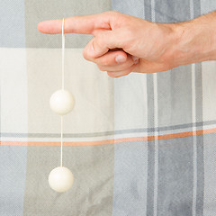 Image showing Hand holding white vaginal balls, isolated