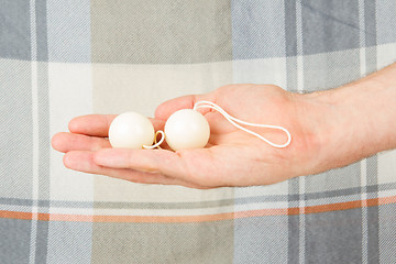 Image showing Hand holding white vaginal balls, isolated