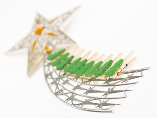 Image showing Falling star, christmas decoration with small clothing pins isol