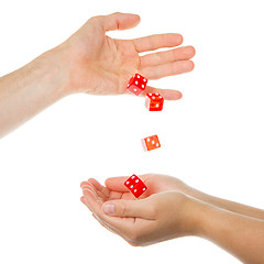 Image showing Five red dice being thrown from a hand