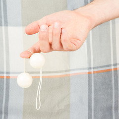 Image showing Hand holding white vaginal balls, isolated