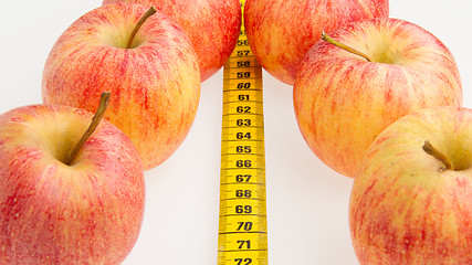 Image showing Red apples with a yellow tape-measure