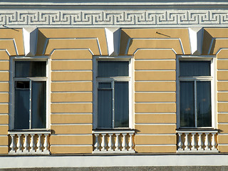 Image showing Yellow windows in an old building