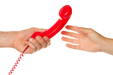 Image showing Man giving red telephone to woman