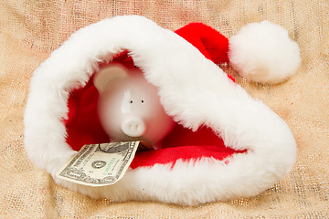 Image showing Piggybank guarding Santa's crisis budget