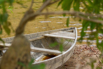 Image showing Small rowing boat on the shore of a small river