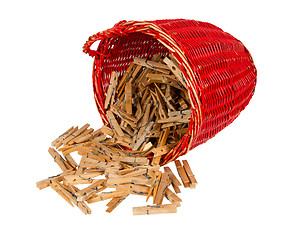 Image showing Very old red basket with wooden clothespins