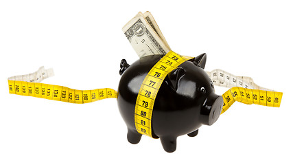 Image showing Black piggy bank with measuring tape