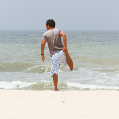 Image showing Man stretching on the beach at the south chinese sea 