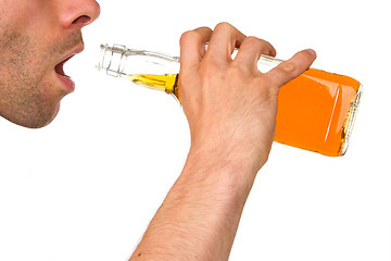 Image showing Man drinking alcohol out of a bottle