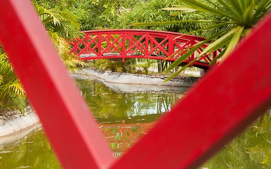 Image showing Red bridge over water in a Japanese garden