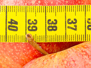 Image showing Red apples with a yellow tape-measure