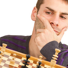 Image showing Chessboard with desperate man thinking about chess strategy, iso